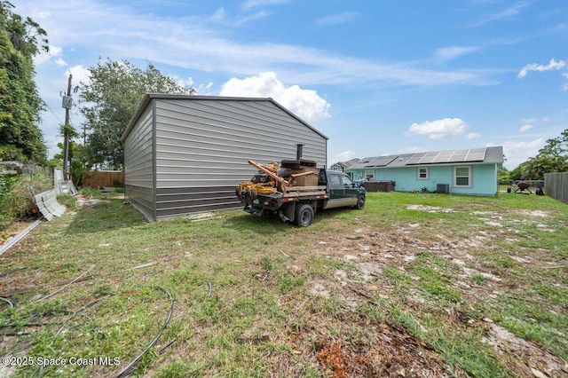 926 Caligula Ave SE, Palm Bay, FL 32909 - back of house with solar panels and an outdoor structure