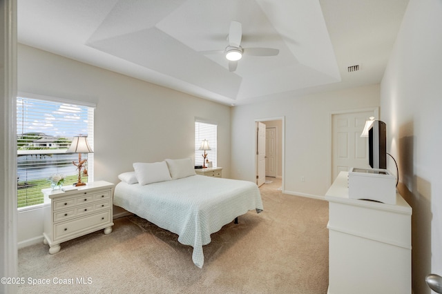 4299 Alligator Flag Cir, West Melbourne, FL 32904 - bedroom with a tray ceiling, light carpet, ceiling fan, and baseboards