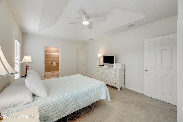 4299 Alligator Flag Cir, West Melbourne, FL 32904 - bedroom with a raised ceiling, light carpet, ensuite bath, a ceiling fan, and baseboards