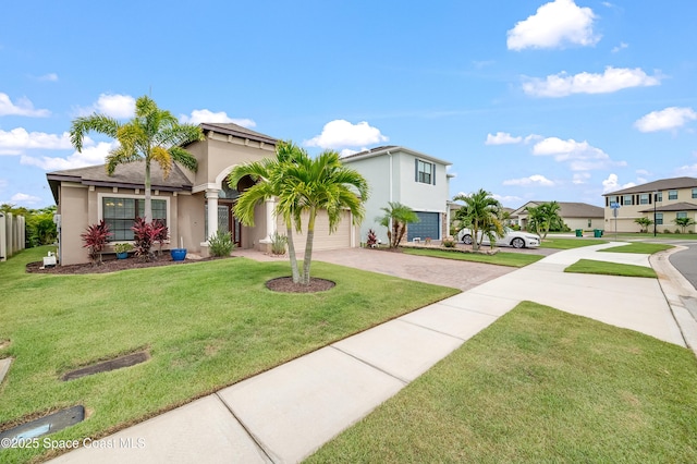 4299 Alligator Flag Cir, West Melbourne, FL 32904 - mediterranean / spanish-style house with decorative driveway, stucco siding, and a front yard