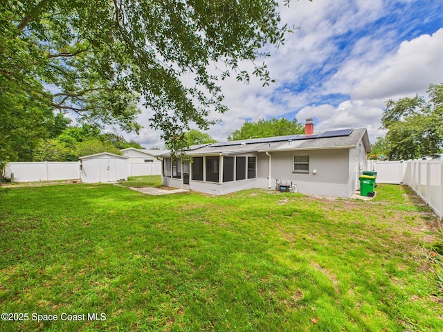 2115 Otterbein Ave, Cocoa, FL 32926 - back of house with a sunroom, roof mounted solar panels, and a chimney