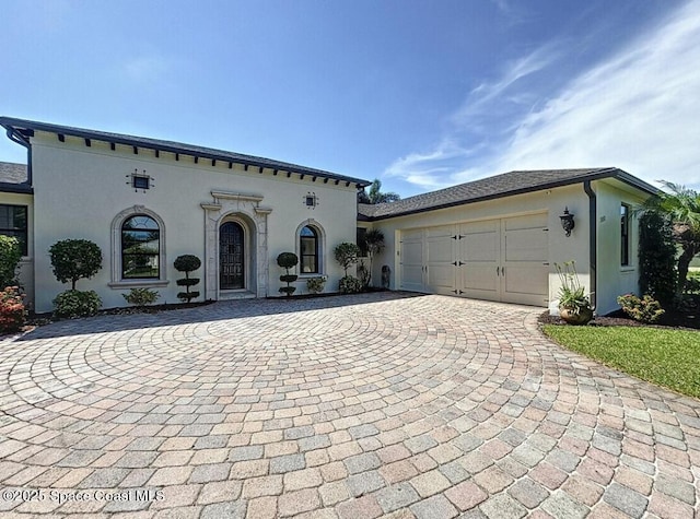 3180 Savannahs Trl, Merritt Island, FL 32953 - view of front of home with stucco siding, decorative driveway, and an attached garage