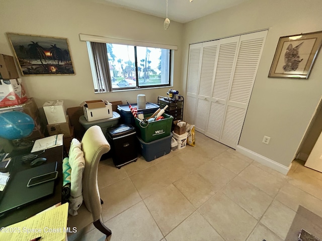 2915 Kirkland Rd NE, Palm Bay, FL 32905 - bedroom featuring a closet, light tile patterned floors, and baseboards