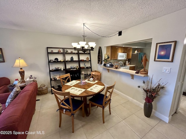 2915 Kirkland Rd NE, Palm Bay, FL 32905 - dining space with a chandelier, light tile patterned flooring, and a textured ceiling