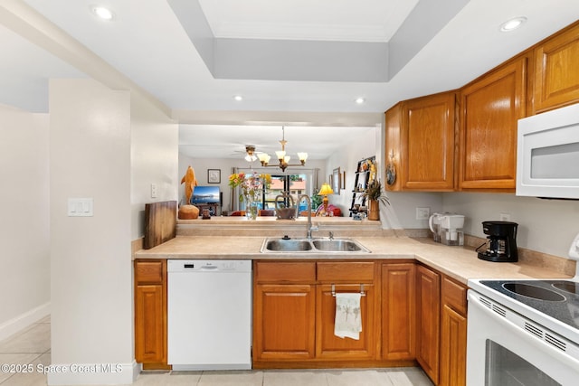 2915 Kirkland Rd NE, Palm Bay, FL 32905 - kitchen with white appliances, light countertops, brown cabinetry, recessed lighting, and light tile patterned floors