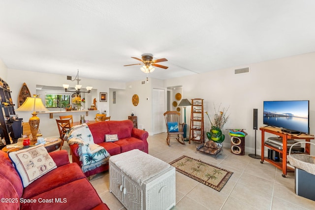 2915 Kirkland Rd NE, Palm Bay, FL 32905 - living room with a ceiling fan, light tile patterned floors, and a chandelier