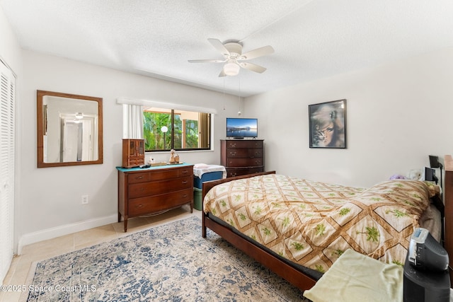 2915 Kirkland Rd NE, Palm Bay, FL 32905 - bedroom featuring light tile patterned flooring, a textured ceiling, and a ceiling fan