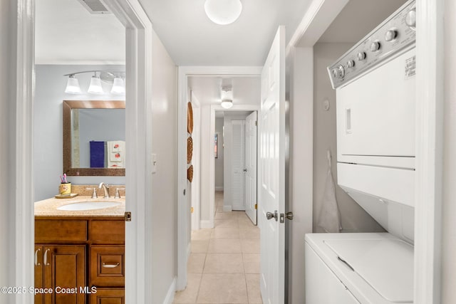 2915 Kirkland Rd NE, Palm Bay, FL 32905 - washroom with stacked washer and clothes dryer and light tile patterned floors