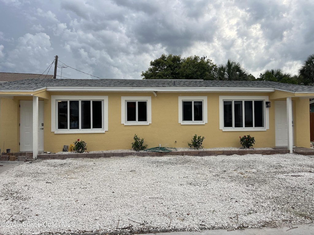 6409 Ridgewood Ave Unit 6409, Cocoa Beach, FL 32931 - view of front of home featuring stucco siding and a shingled roof