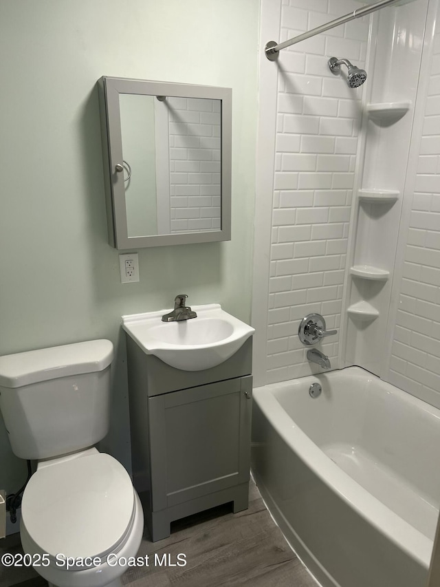 6409 Ridgewood Ave Unit 6409, Cocoa Beach, FL 32931 - bathroom featuring vanity, toilet,  shower combination, and wood finished floors