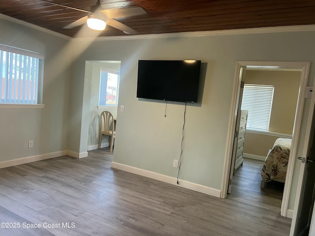 6409 Ridgewood Ave Unit 6409, Cocoa Beach, FL 32931 - unfurnished living room featuring crown molding, healthy amount of natural light, wooden ceiling, ceiling fan, and baseboards