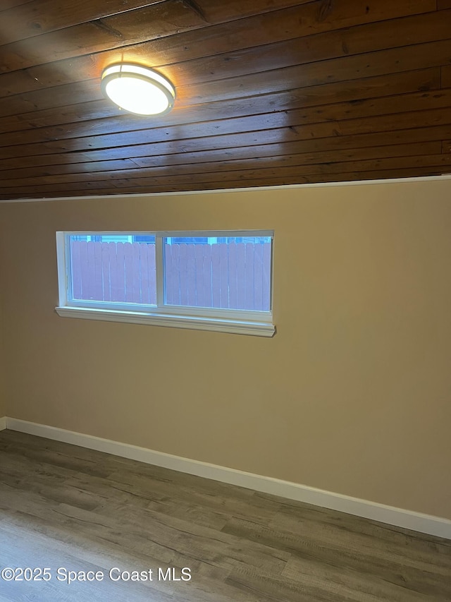 6409 Ridgewood Ave Unit 6409, Cocoa Beach, FL 32931 - empty room with wooden ceiling, wood finished floors, and baseboards