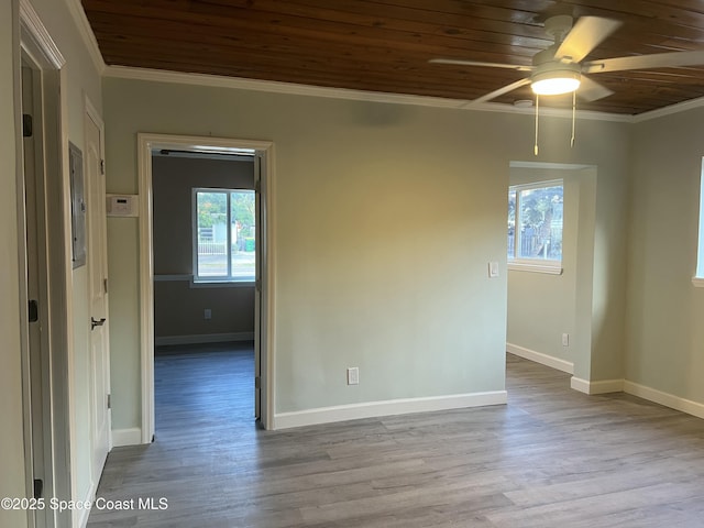 6409 Ridgewood Ave Unit 6409, Cocoa Beach, FL 32931 - spare room featuring wooden ceiling, healthy amount of natural light, wood finished floors, a ceiling fan, and baseboards