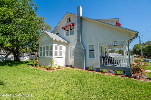 1248 Highland Ave, Melbourne, FL 32935 - rear view of property featuring a porch, a chimney, a ceiling fan, and crawl space
