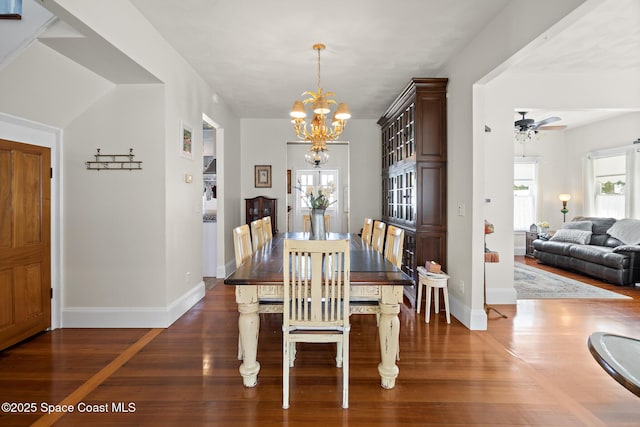 1248 Highland Ave, Melbourne, FL 32935 - dining room featuring a chandelier, wood finished floors, healthy amount of natural light, and baseboards
