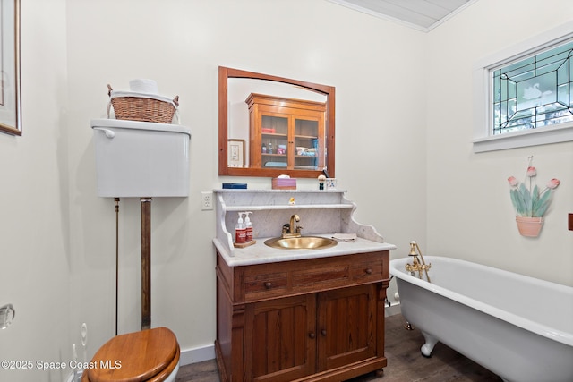 1248 Highland Ave, Melbourne, FL 32935 - bathroom with a freestanding bath, wood finished floors, vanity, and baseboards