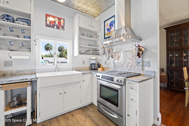 1248 Highland Ave, Melbourne, FL 32935 - kitchen with stainless steel gas stove, wall chimney exhaust hood, a sink, light wood finished floors, and an ornate ceiling