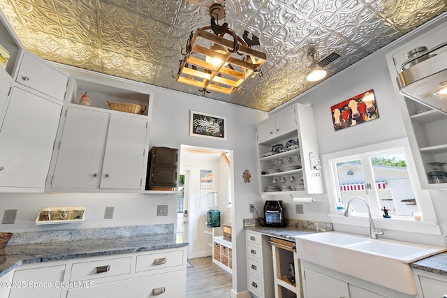 1248 Highland Ave, Melbourne, FL 32935 - kitchen featuring open shelves, an ornate ceiling, a sink, light wood-style floors, and white cabinets