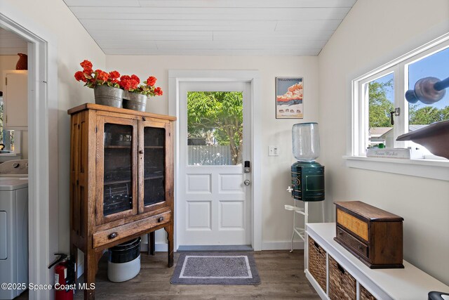 1248 Highland Ave, Melbourne, FL 32935 - doorway to outside featuring washer / clothes dryer, healthy amount of natural light, dark wood-style floors, and wooden ceiling
