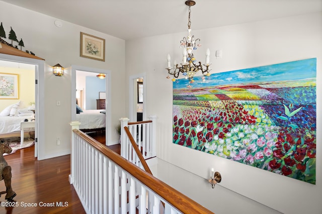 1248 Highland Ave, Melbourne, FL 32935 - hallway featuring an upstairs landing, dark wood-type flooring, and a chandelier