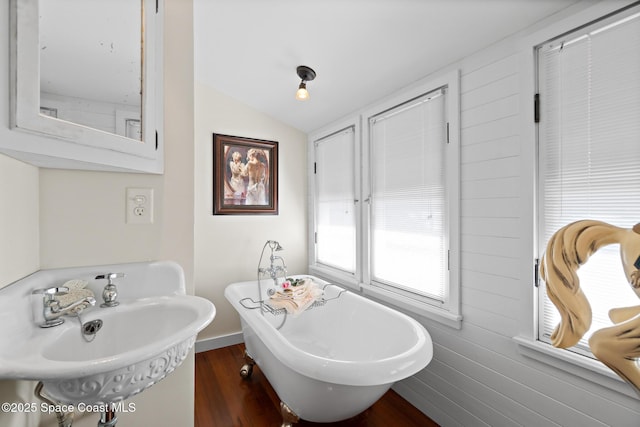 1248 Highland Ave, Melbourne, FL 32935 - bathroom with a soaking tub, wood finished floors, a sink, and vaulted ceiling