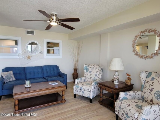 2100 N Atlantic Ave Unit 1207, Cocoa Beach, FL 32931 - living area with light wood finished floors, a textured ceiling, and a ceiling fan