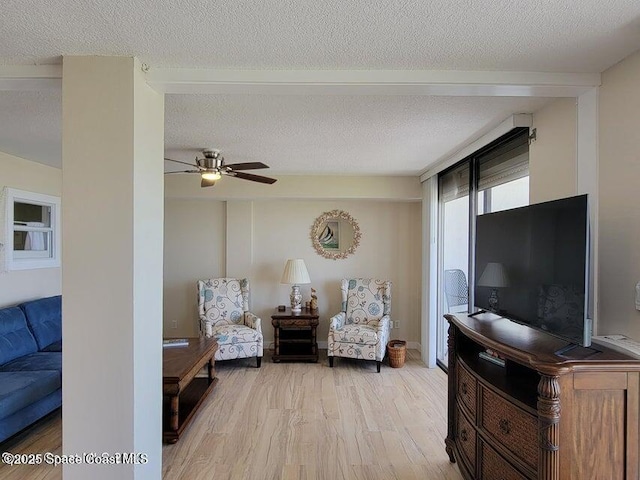 2100 N Atlantic Ave Unit 1207, Cocoa Beach, FL 32931 - living room with light wood-style flooring, a ceiling fan, and a textured ceiling