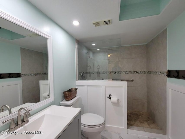 2100 N Atlantic Ave Unit 1207, Cocoa Beach, FL 32931 - bathroom with vanity, a walk in shower, toilet, and recessed lighting