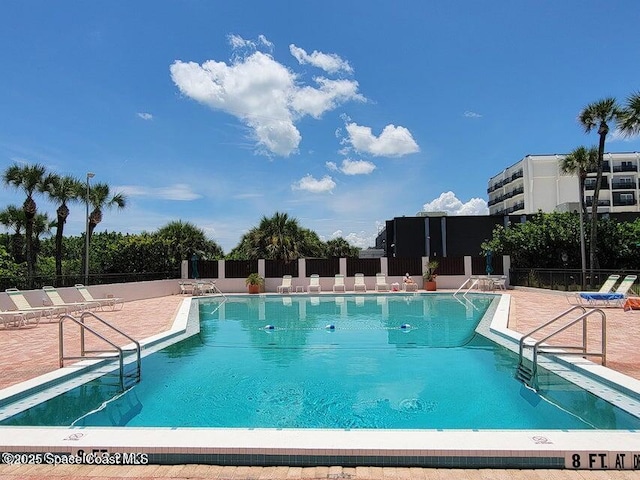 2100 N Atlantic Ave Unit 1207, Cocoa Beach, FL 32931 - community pool featuring a patio area
