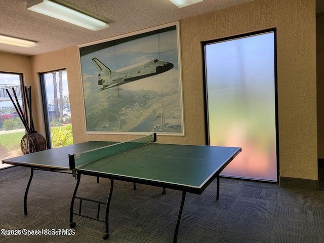 2100 N Atlantic Ave Unit 1207, Cocoa Beach, FL 32931 - recreation room featuring carpet flooring, a textured wall, and a textured ceiling