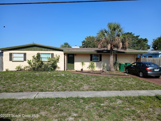 900 E Richland Ave, Merritt Island, FL 32953 - ranch-style home with a garage and brick siding