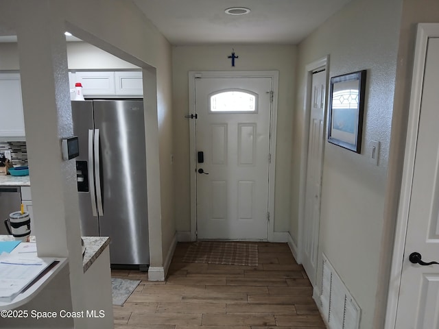 900 E Richland Ave, Merritt Island, FL 32953 - entryway with light wood finished floors and baseboards