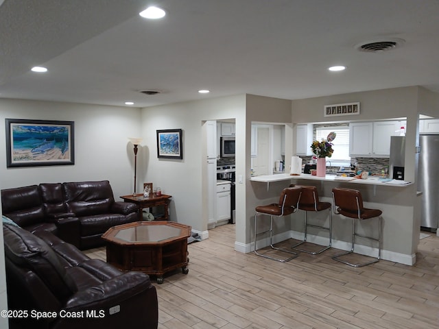 900 E Richland Ave, Merritt Island, FL 32953 - living area featuring light wood-style floors and recessed lighting