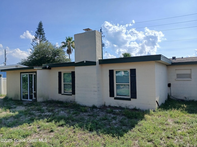 900 E Richland Ave, Merritt Island, FL 32953 - back of property with concrete block siding and a chimney