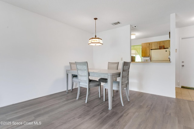 741 Alaska Ave NE, Palm Bay, FL 32907 - dining space with wood finished floors, a chandelier, and baseboards