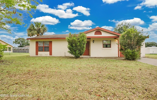 741 Alaska Ave NE, Palm Bay, FL 32907 - ranch-style home with stucco siding and a front yard
