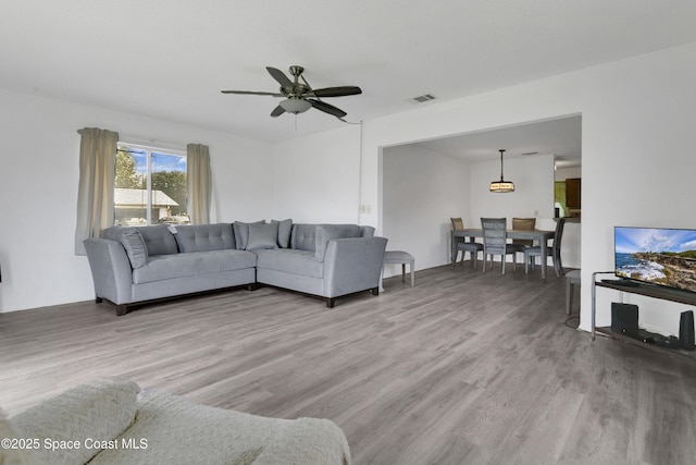 741 Alaska Ave NE, Palm Bay, FL 32907 - living room with wood finished floors and ceiling fan