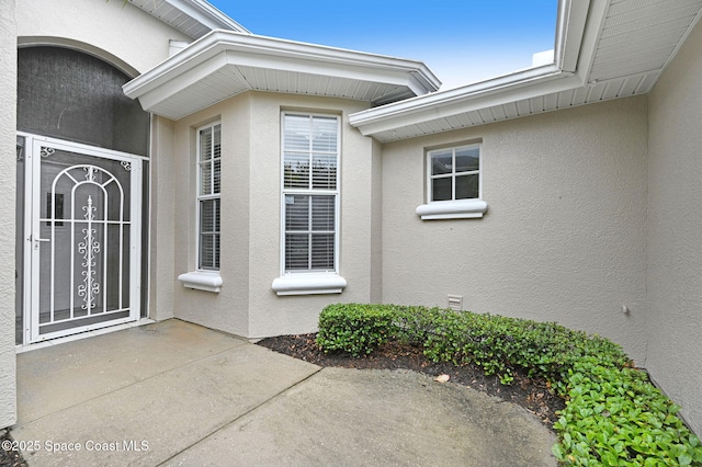 4224 Woodhall Cir, Rockledge, FL 32955 - view of exterior entry featuring stucco siding and a patio