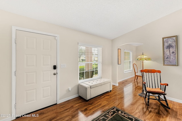 775 Triple Crown Ln, Melbourne, FL 32904 - entryway featuring wood finished floors, baseboards, vaulted ceiling, and a textured ceiling