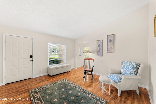 775 Triple Crown Ln, Melbourne, FL 32904 - entrance foyer featuring wood finished floors, vaulted ceiling, baseboards, and arched walkways