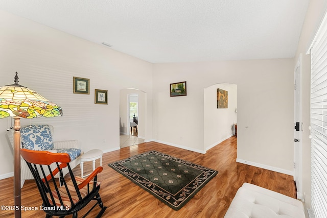 775 Triple Crown Ln, Melbourne, FL 32904 - sitting room featuring arched walkways, wood finished floors, and baseboards