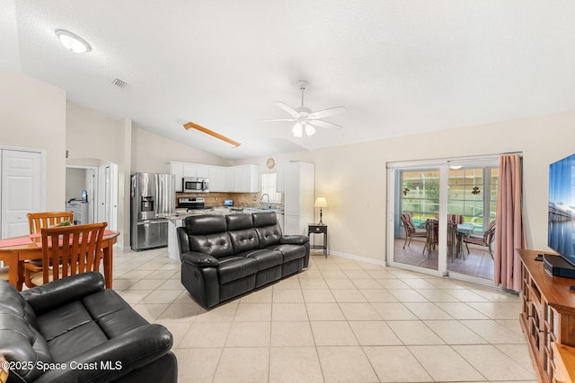 775 Triple Crown Ln, Melbourne, FL 32904 - living room with lofted ceiling, ceiling fan, light tile patterned floors, baseboards, and a textured ceiling