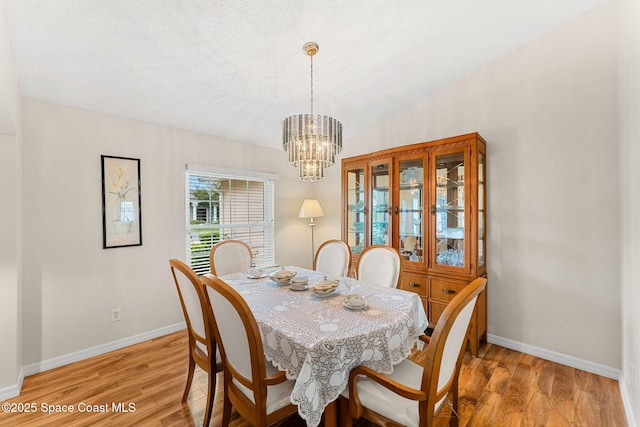 775 Triple Crown Ln, Melbourne, FL 32904 - dining space with light wood-style flooring, baseboards, and a chandelier