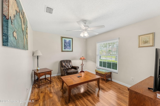 775 Triple Crown Ln, Melbourne, FL 32904 - living area featuring wood finished floors, a textured ceiling, ceiling fan, and baseboards