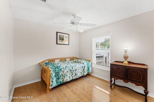 775 Triple Crown Ln, Melbourne, FL 32904 - bedroom with wood finished floors, baseboards, a textured ceiling, and ceiling fan