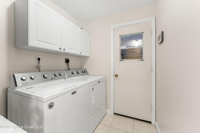 775 Triple Crown Ln, Melbourne, FL 32904 - laundry room featuring washing machine and dryer, cabinet space, light tile patterned floors, and baseboards