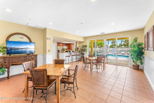 505 S Miramar Ave Unit 2403, Indialantic, FL 32903 - dining space featuring a textured ceiling, recessed lighting, light tile patterned floors, and wainscoting