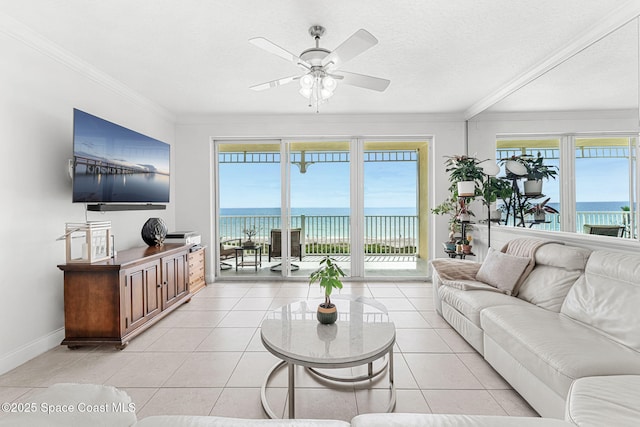 505 S Miramar Ave Unit 2403, Indialantic, FL 32903 - living room with ceiling fan, healthy amount of natural light, crown molding, baseboards, and light tile patterned floors