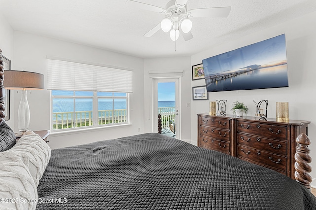 505 S Miramar Ave Unit 2403, Indialantic, FL 32903 - bedroom featuring access to exterior, multiple windows, and a ceiling fan