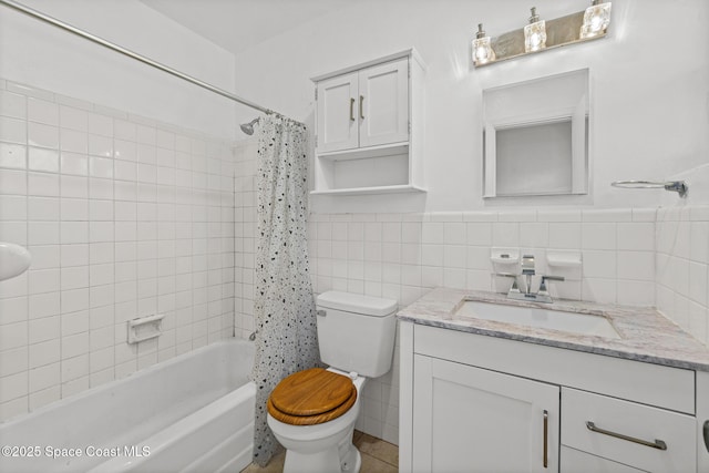 3820 Ocean Beach Blvd Unit 1, Cocoa Beach, FL 32931 - full bath with tile walls, toilet, vanity, shower / bathtub combination with curtain, and wainscoting